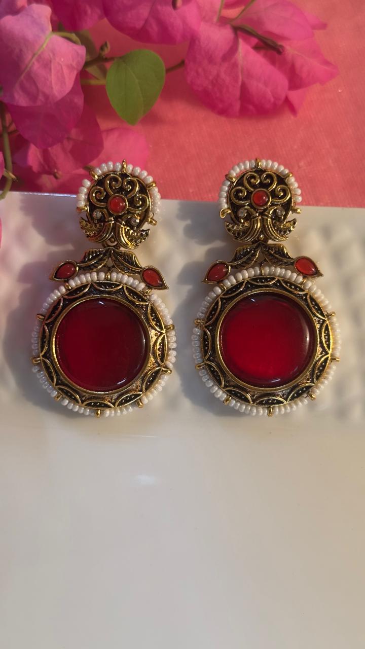 red antique gold tone earrings.
